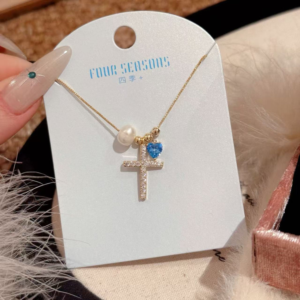 Pearl and zircon cross necklace packaged as thoughtful gift