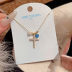 Pearl and zircon cross necklace packaged as thoughtful gift