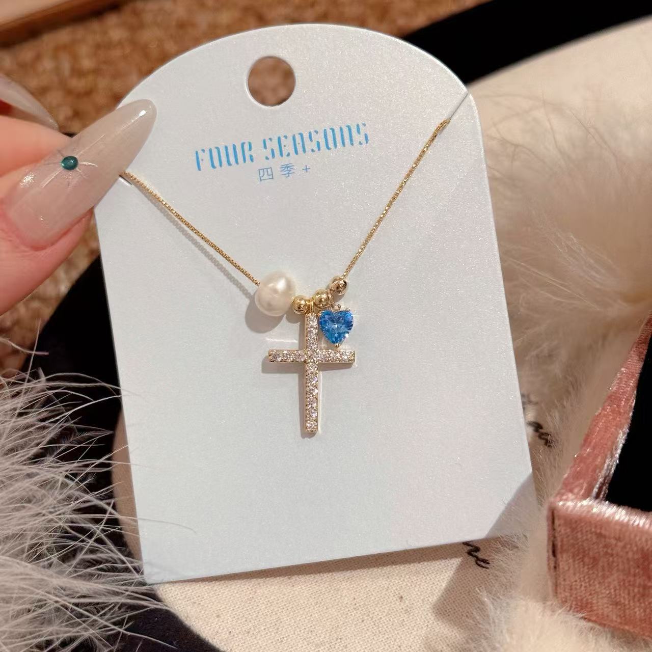 Pearl and zircon cross necklace packaged as thoughtful gift