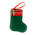Set of four fabric Christmas stocking-shaped pendants in festive colors hanging together