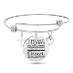 Silver stainless steel bangle bracelet with cross pendant close-up