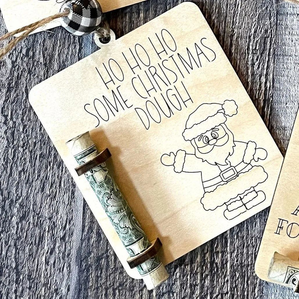 Close-up view of rustic wooden Christmas money clip with tree motif