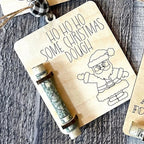 Close-up view of rustic wooden Christmas money clip with tree motif