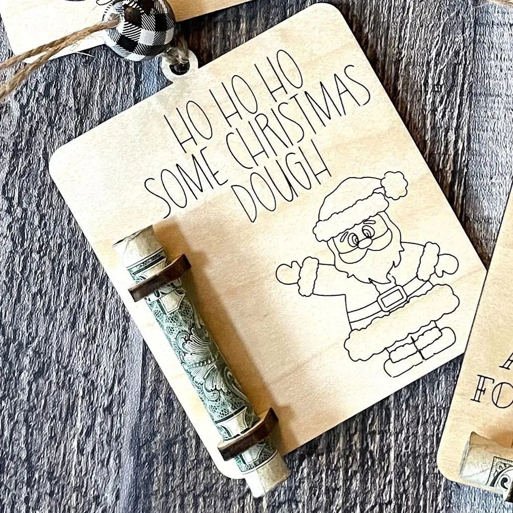 Close-up view of rustic wooden Christmas money clip with tree motif