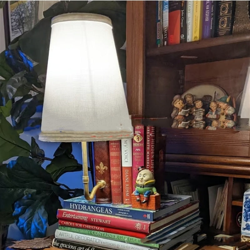 Christmas classic literary lamp displayed on wooden shelf