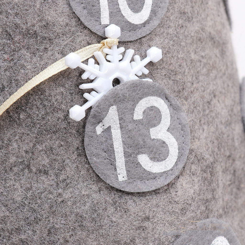 Christmas countdown doll displayed on snowy mantelpiece with other holiday decorations