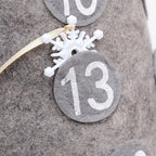 Christmas countdown doll displayed on snowy mantelpiece with other holiday decorations
