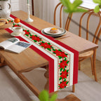 Christmas table runner with red and gold design displayed at festive holiday dinner setting
