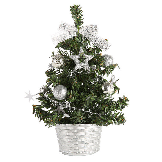 Mini desktop Christmas tree decoration on wooden surface with warm lighting for home