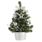 Mini desktop Christmas tree decoration on wooden surface with warm lighting for home