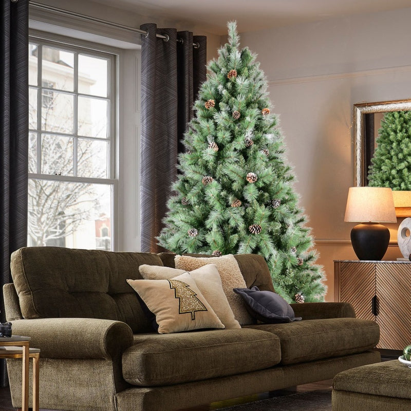 Natural pine cones arranged around the base of a green Christmas tree