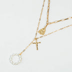 Elegant golden cross necklace with intricate chain design for women