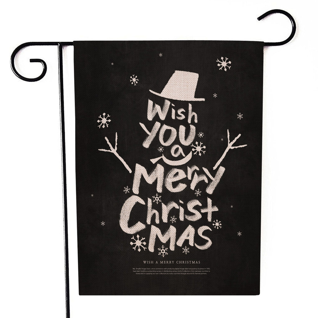 Santa Claus garden flag with cheerful holiday design displayed outdoors in snowy setting
