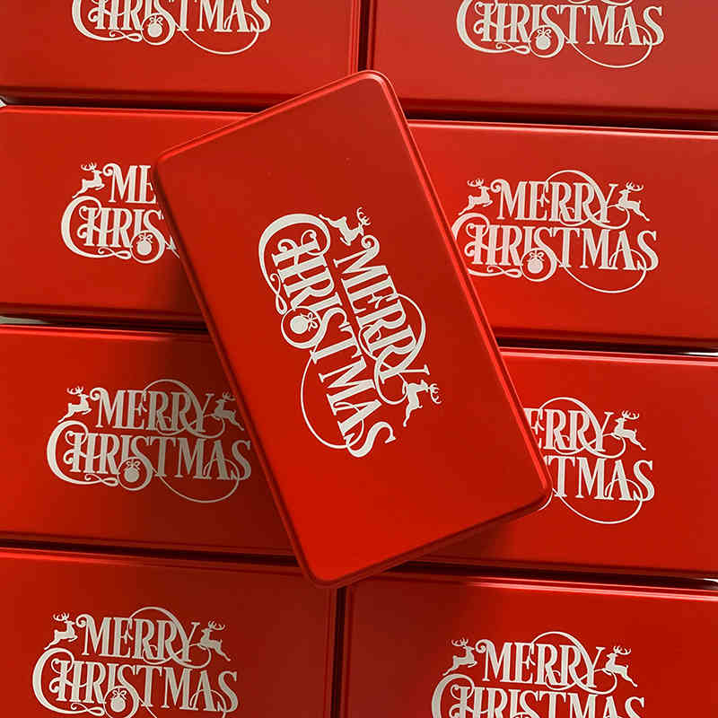 Cookie gift tin with red and gold pattern design on rustic table setting