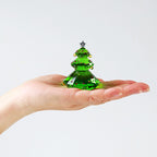 Christmas tree ornament with warm lighting in festive setting