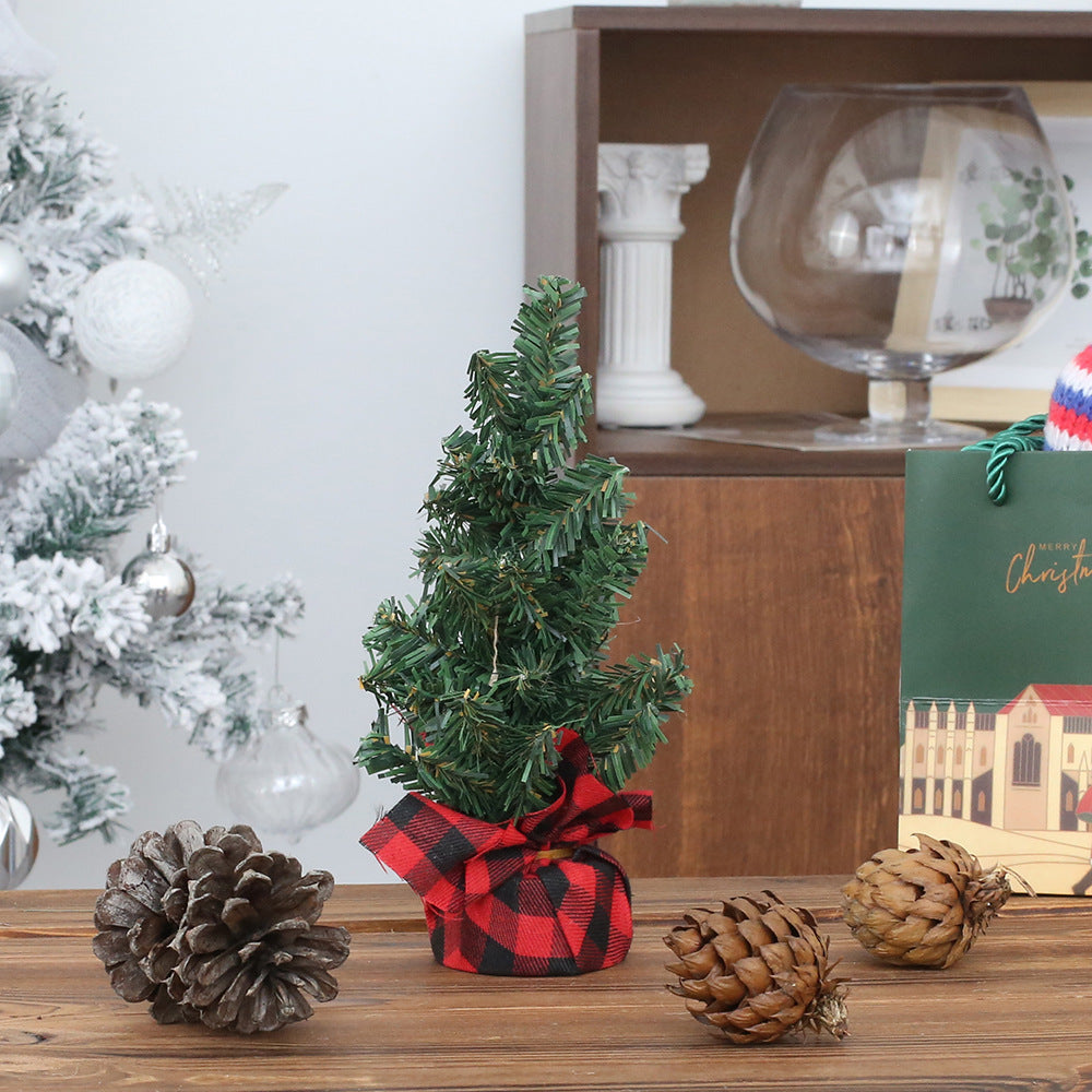 Group of pine needle Christmas trees in multiple sizes 15 to 40 CM, red and black and linen bases, holiday decor display