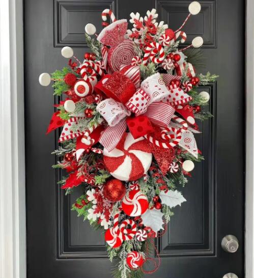 Festive Christmas door hanging with colorful wreath design on textured background