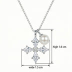 Close-up of sparkling kite-shaped cubic zirconia stones on a silver cross pendant