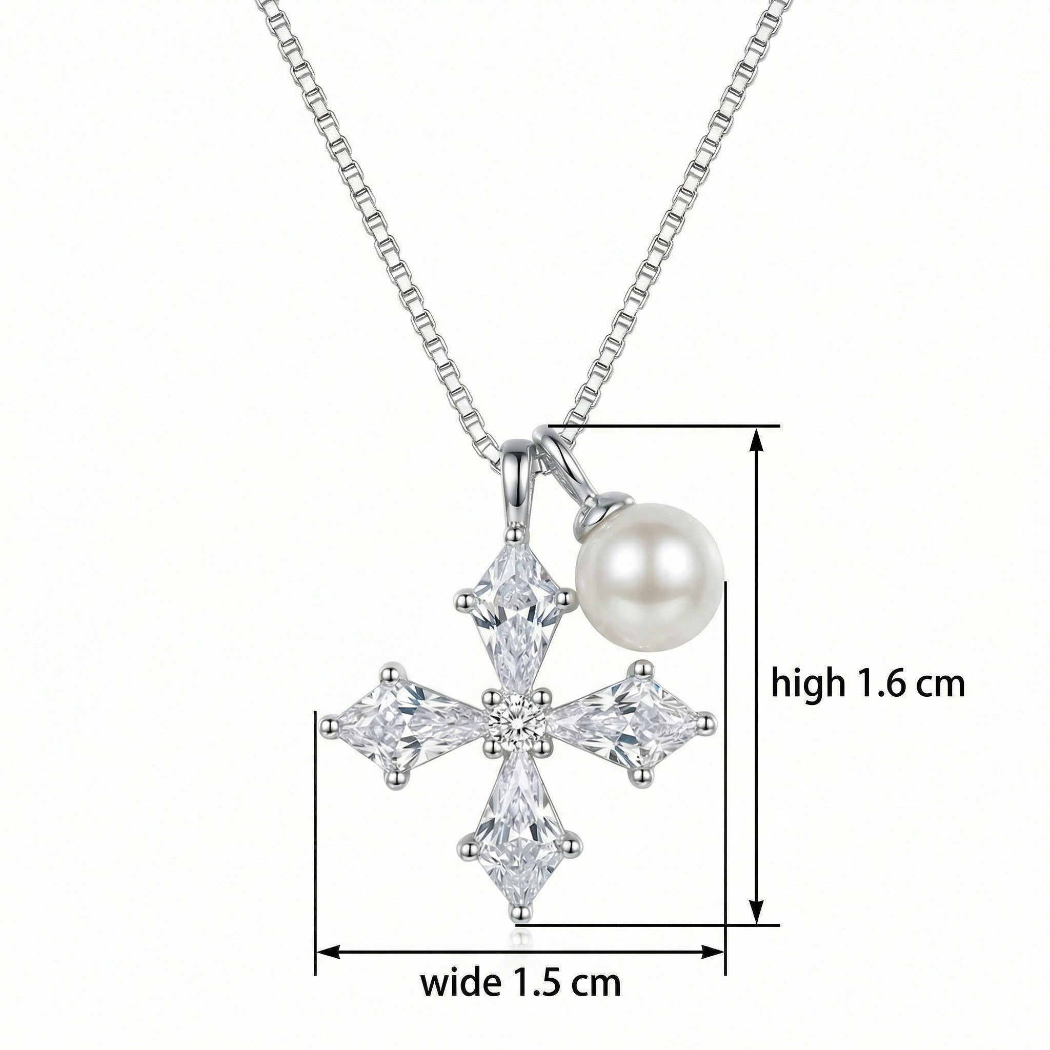 Close-up of sparkling kite-shaped cubic zirconia stones on a silver cross pendant