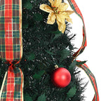 Festive green Christmas tree with warm white LED lights in cozy indoor setting