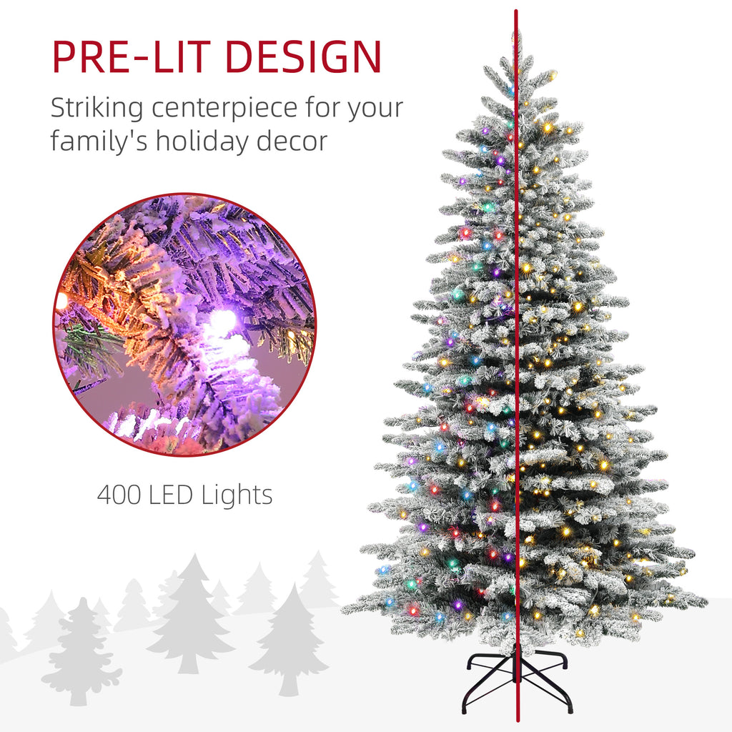 Snow-flocked branches of a 6.5ft artificial Christmas tree in a home setting