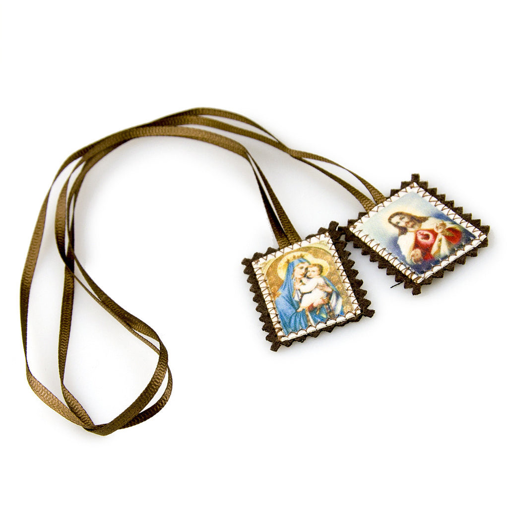 Cloth pendant and ruler showing the 4 by 3 centimeter size of the ornament